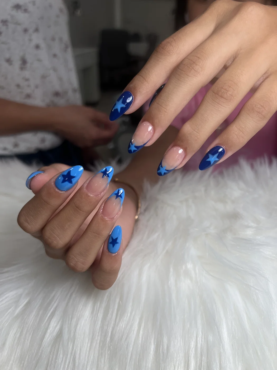 Royal blue almond nails with star nail art accents