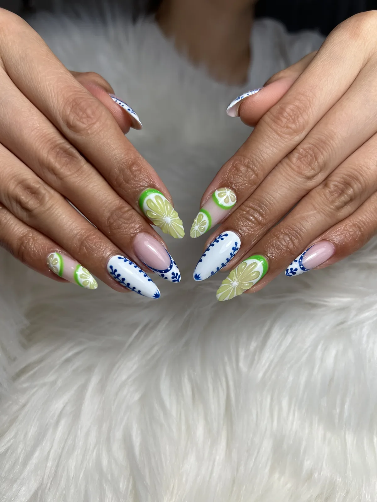 Almond nails with cobalt-blue porcelain pattern and hand-painted lime slice accents
