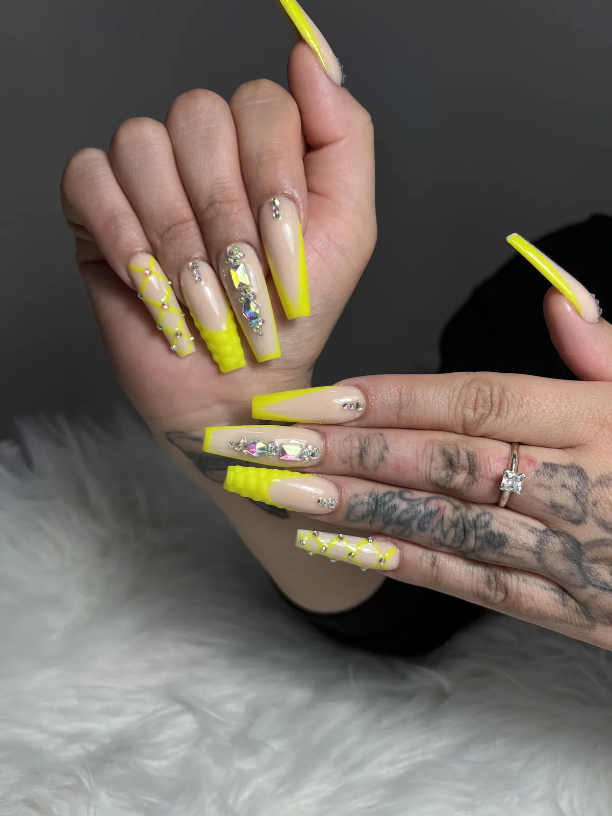 Long coffin nails with neon yellow tips, crystal gem clusters and 3D quilted accents