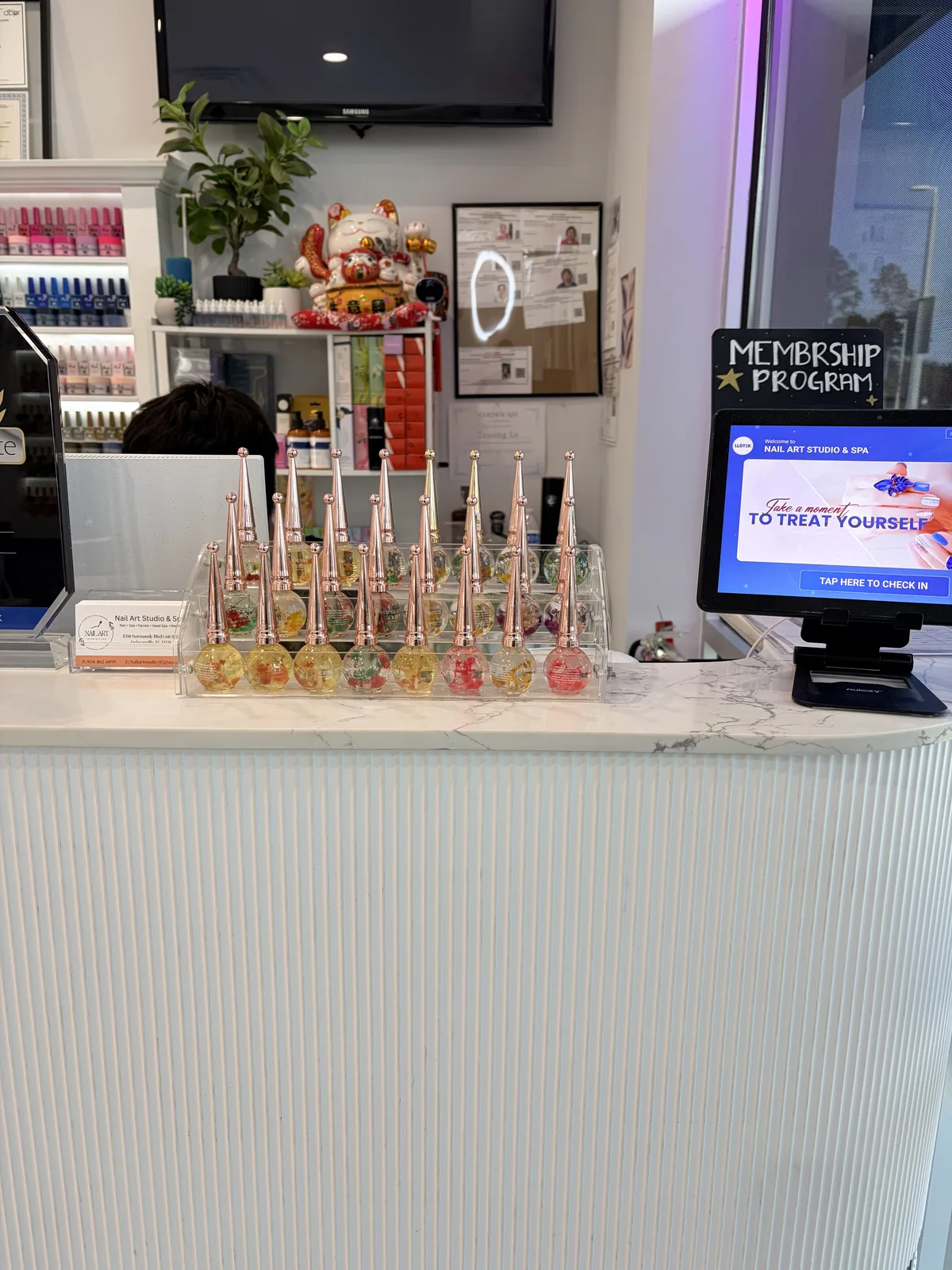 Front entrance of Nail Art Studio & Spa with brass signage