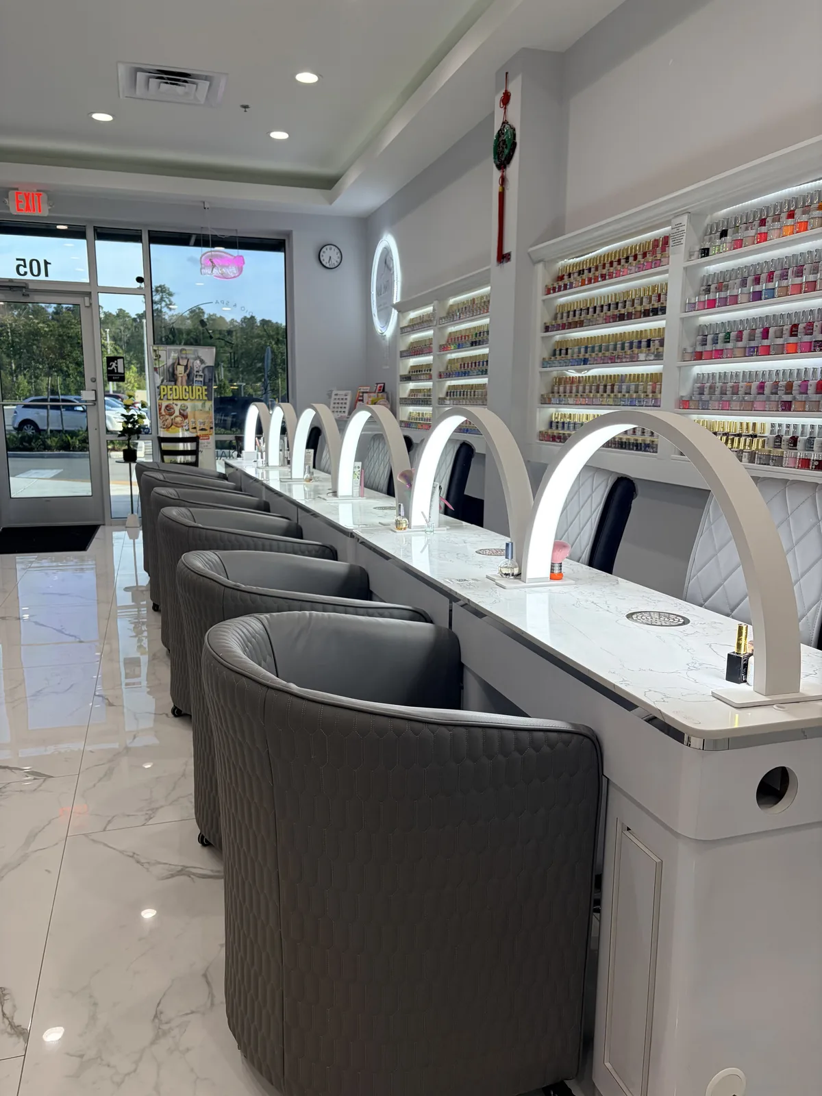 Manicure stations at Nail Art Studio & Spa with marble counters and warm lighting
