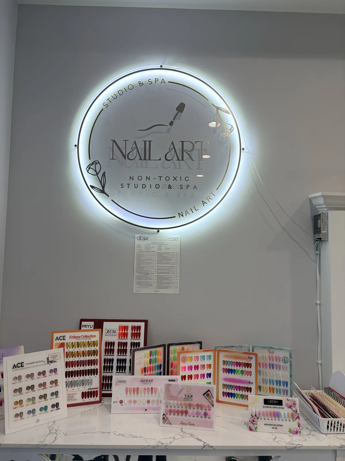Cozy seating nook at Nail Art Studio & Spa with a complimentary glass of wine
